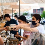 從攤販?zhǔn)种薪舆^(guò)最適合午後享用的輕食，攤販同時(shí)將心意以雙手一同遞上，彼此的這份互動(dòng)是盛夏美好的一景。